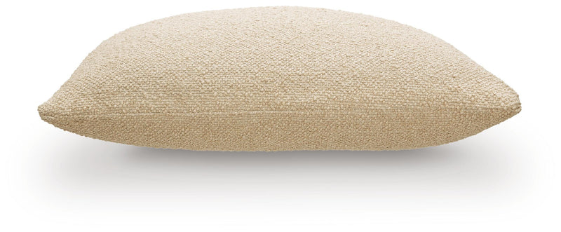 Set of four Ashley Furniture Macsen pillows with decorative fabric, shown arranged on a sofa for stylish home décor.