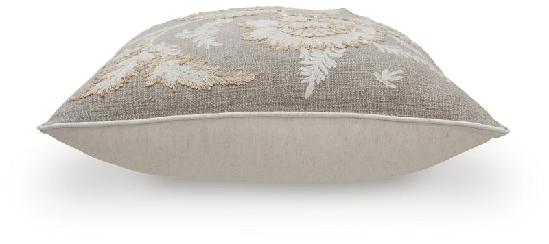 Set of four Ashley Furniture Viveka pillows with soft fabric covers and decorative patterns, displayed on a cozy sofa.