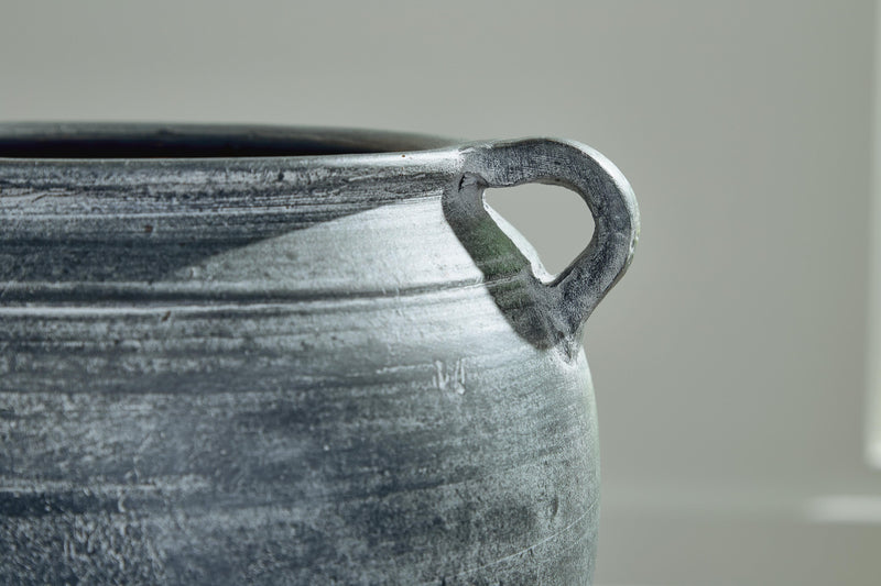 Close-up of the Ashley Furniture Meadie Vase with intricate design and a sleek, modern shape.