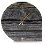Two Ashley Furniture Janmour table clocks with round faces and modern black and white designs, perfect as stylish tabletop accessories.