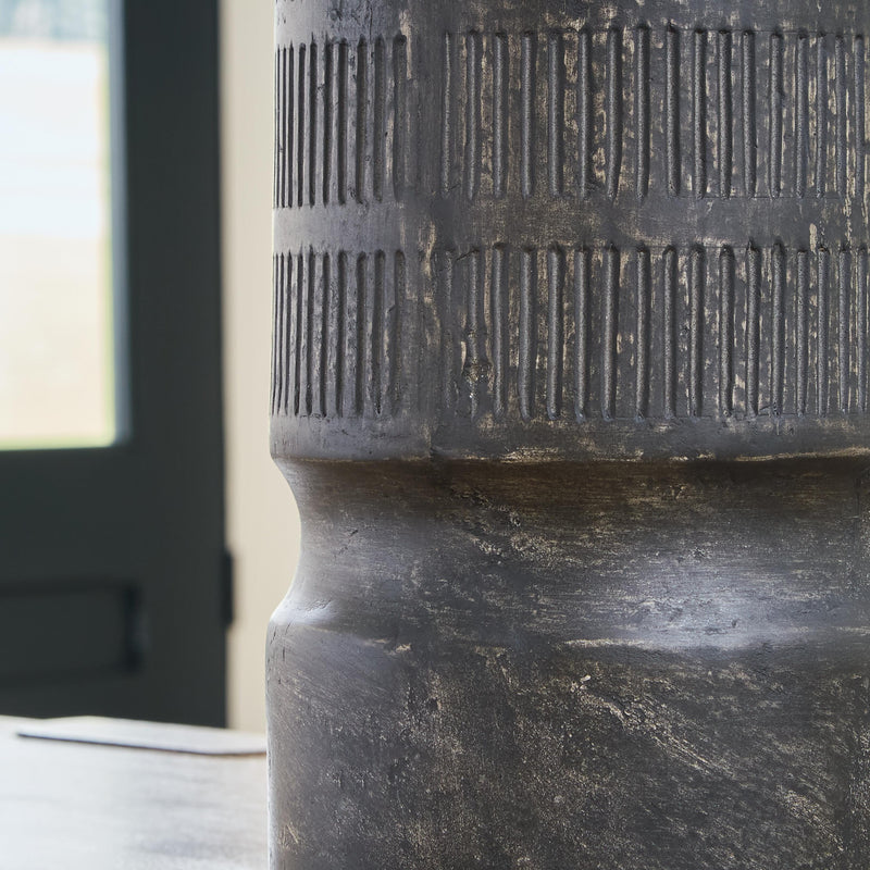 Ashley Furniture Beninworth Vase with intricate patterns and a glossy finish, displayed on a wooden surface.