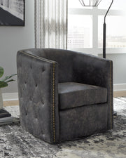 Ashley Furniture Brentlow swivel accent chair with plush fabric and wooden legs, shown in a modern living room setting.