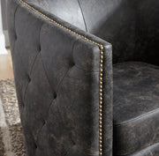 Ashley Furniture Brentlow swivel accent chair with plush fabric and modern design, shown in a cozy living room setting.