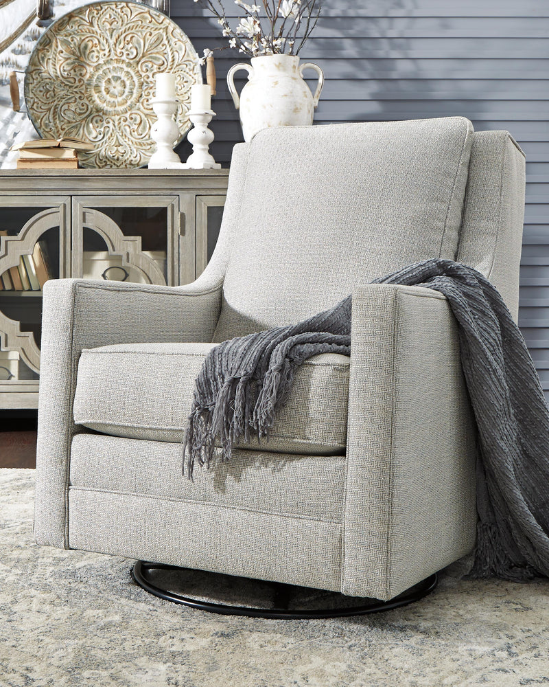 Ashley Furniture Kambria swivel glider accent chair with plush upholstery and wooden legs, shown in a cozy living room setting.