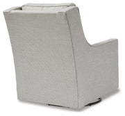 Ashley Furniture Kambria swivel glider accent chair with plush upholstery and wooden base, shown from the back.