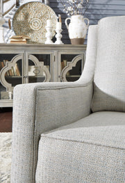 Ashley Furniture Kambria swivel glider accent chair with plush fabric and cushioned seat, perfect for living room or lounge space.