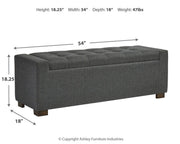 Ashley Furniture Cortwell Storage Bench with cushioned top and wooden legs, ideal for entryway or living room storage.