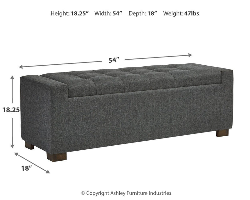 Ashley Furniture Cortwell Storage Bench with cushioned top and wooden legs, ideal for entryway or living room storage.