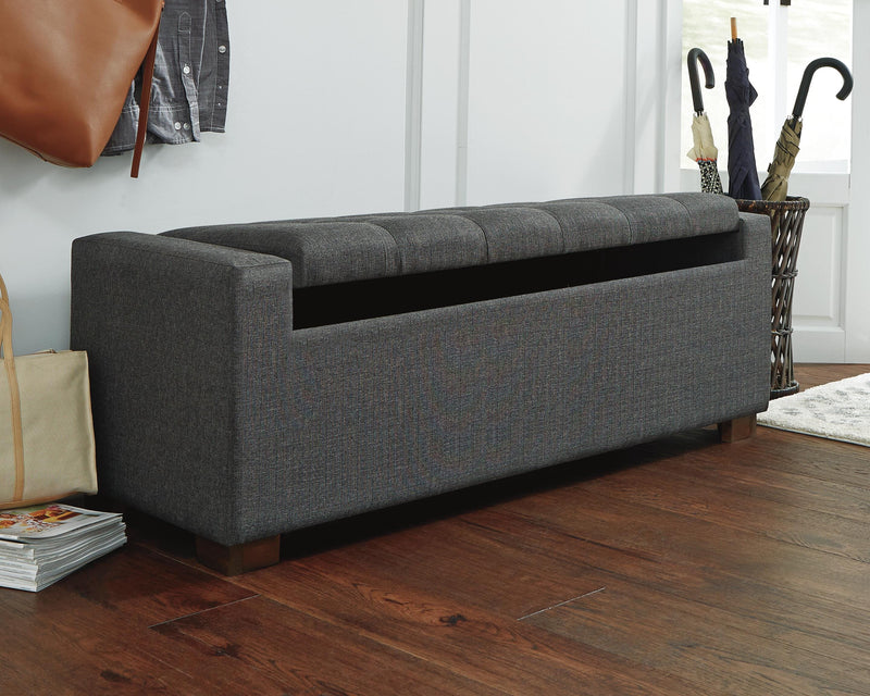 Ashley Furniture Cortwell storage bench with wooden top and fabric base, featuring open storage and cushioned seating.