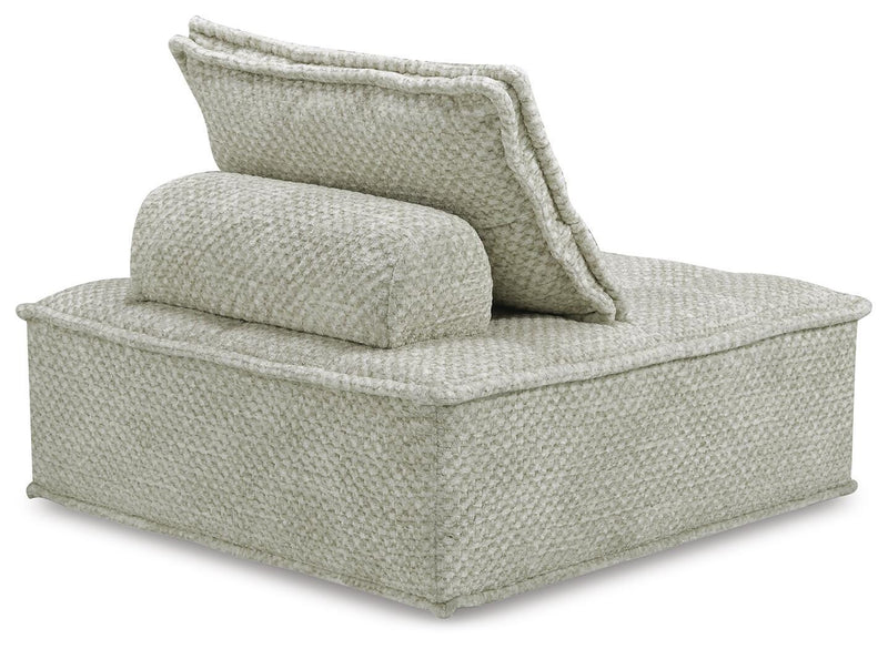 Ashley Furniture Bales accent chair with plush fabric and wooden legs, shown from the back in a modern living room setting.