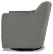 Ashley Furniture Bradney swivel accent chair with plush fabric and modern design, shown from a side angle.