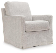 Ashley Furniture Nenana Next-Gen Nuvella swivel accent chair with plush upholstery and modern design, shown from an angled side view.