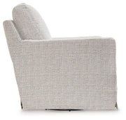 Ashley Furniture Nenana Next-Gen Nuvella swivel glider accent chair with plush fabric and modern design, shown from the side.