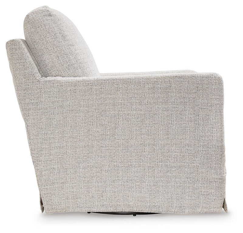 Ashley Furniture Nenana Next-Gen Nuvella swivel glider accent chair with plush fabric and modern design, shown from the side.
