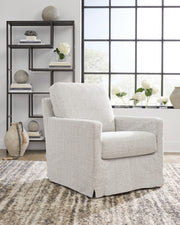 Ashley Furniture Nenana Next-Gen Nuvella swivel accent chair with plush cushioning and modern design, shown in a cozy living room setting.