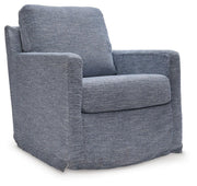 Ashley Furniture Nenana Next-Gen Nuvella swivel accent chair with plush fabric and modern design, shown from an angled side view.