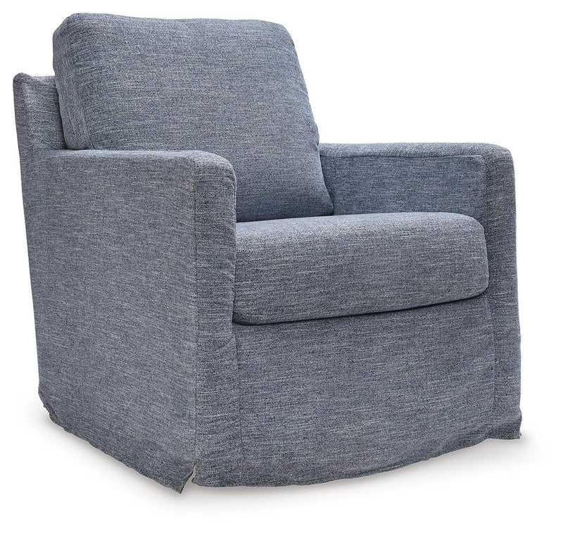 Ashley Furniture Nenana Next-Gen Nuvella swivel accent chair with plush fabric and modern design, shown from an angled side view.