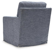 Ashley Furniture Nenana Next-Gen Nuvella swivel accent chair with plush fabric and a modern design, shown from the back.
