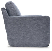 Ashley Furniture Nenana Next-Gen Nuvella swivel accent chair with plush upholstery and a modern design, shown from a side angle.