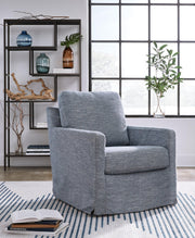 Ashley Furniture Nenana Next-Gen Nuvella swivel accent chair with plush cushioning and modern design, shown in a cozy living room setting.