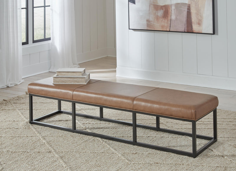 Ashley Furniture Joston accent bench with wooden legs and upholstered seat, ideal for entryways or living rooms.