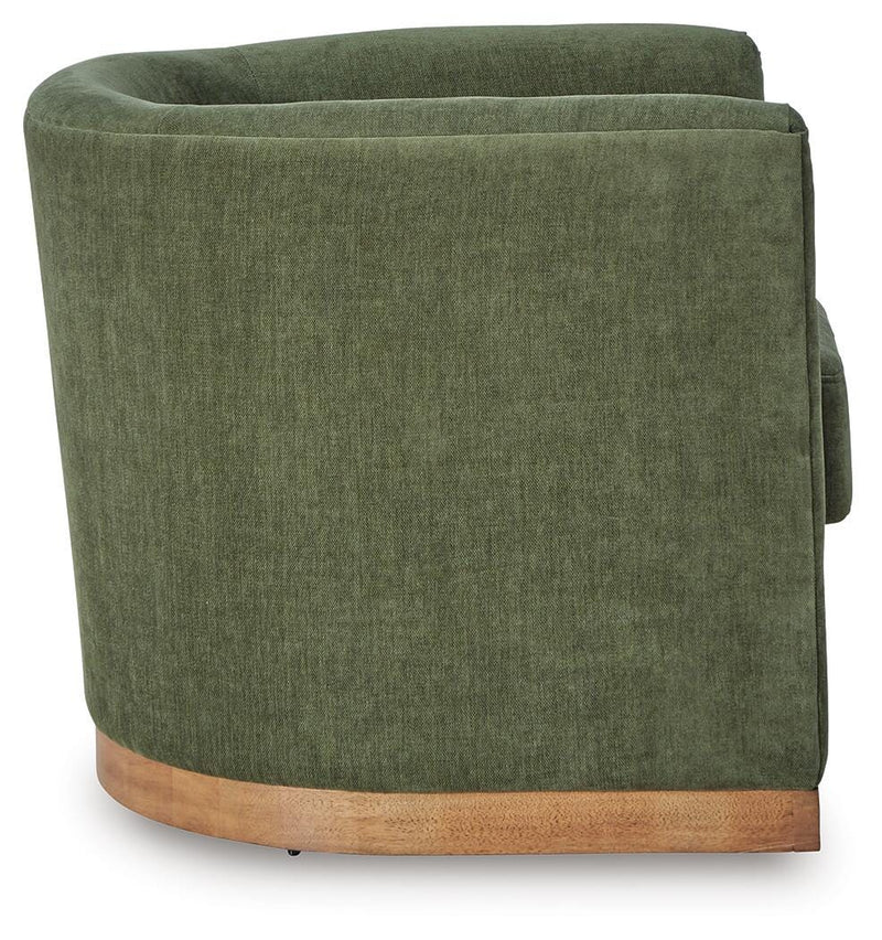 Ashley Furniture Jersonlow swivel accent chair with plush upholstery and wooden legs, shown from a side angle.