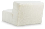 Ashley Furniture Brettner Accent Chair with plush fabric upholstery and wooden legs, shown from the back side.