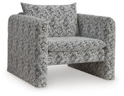 Ashley Furniture Kenbell accent chair with plush fabric and tapered wooden legs, shown from an angled side view.