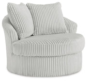 Ashley Furniture Gramwell swivel accent chair with plush fabric upholstery and modern design, shown from an angle.