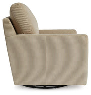 Ashley Furniture Icaman swivel accent chair with plush fabric, shown from the side, featuring a modern design and comfortable seating.