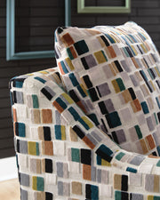 Ashley Furniture Fenna accent chair with plush fabric and wooden legs, showcasing a stylish and comfortable seating option.