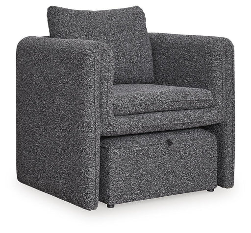 Ashley Furniture Vreni accent chair with plush fabric, curved backrest, and wooden legs in a stylish living room setting.
