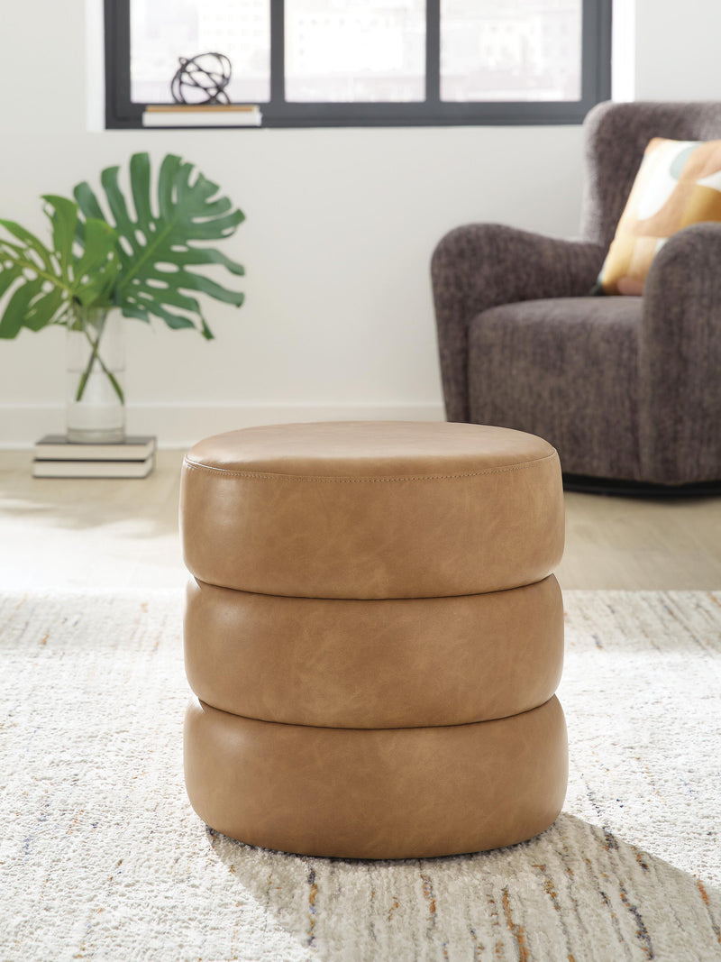 Ashley Furniture Ummi Swivel Accent Ottoman with cushioned top and wooden base, ideal for living room decor.