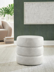Ashley Furniture Ummi Swivel Accent Ottoman with cushioned top and wooden legs, perfect for living room decor.