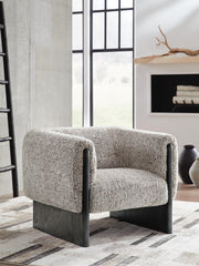 Ashley Furniture Olethea accent chair with plush upholstery and wooden legs, shown in a cozy living room setting.