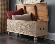 Fossil Ridge storage bench by Ashley Furniture featuring a wooden design with a cushioned top and ample storage space.
