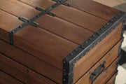 Ashley Furniture Kettleby Storage Trunk showing wooden finish, metal handles, and sturdy construction for versatile storage.
