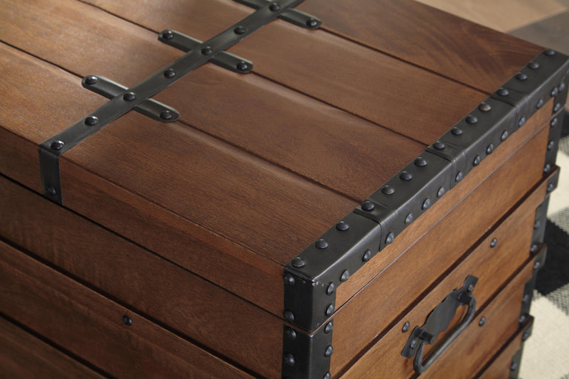 Ashley Furniture Kettleby Storage Trunk showing wooden finish, metal handles, and sturdy construction for versatile storage.