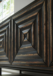 Close-up of the door detail on the Ashley Furniture Fair Ridge Accent Cabinet showcasing its wood grain and elegant design.