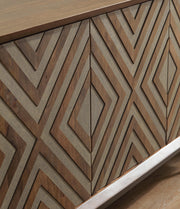 Close-up of the door detail on the Ashley Furniture Dreggan Accent Cabinet, showcasing its elegant wood finish and decorative hardware.