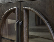 Close-up of the door detail on the Dreley Accent Cabinet by Ashley Furniture, showcasing its elegant wood finish and craftsmanship.