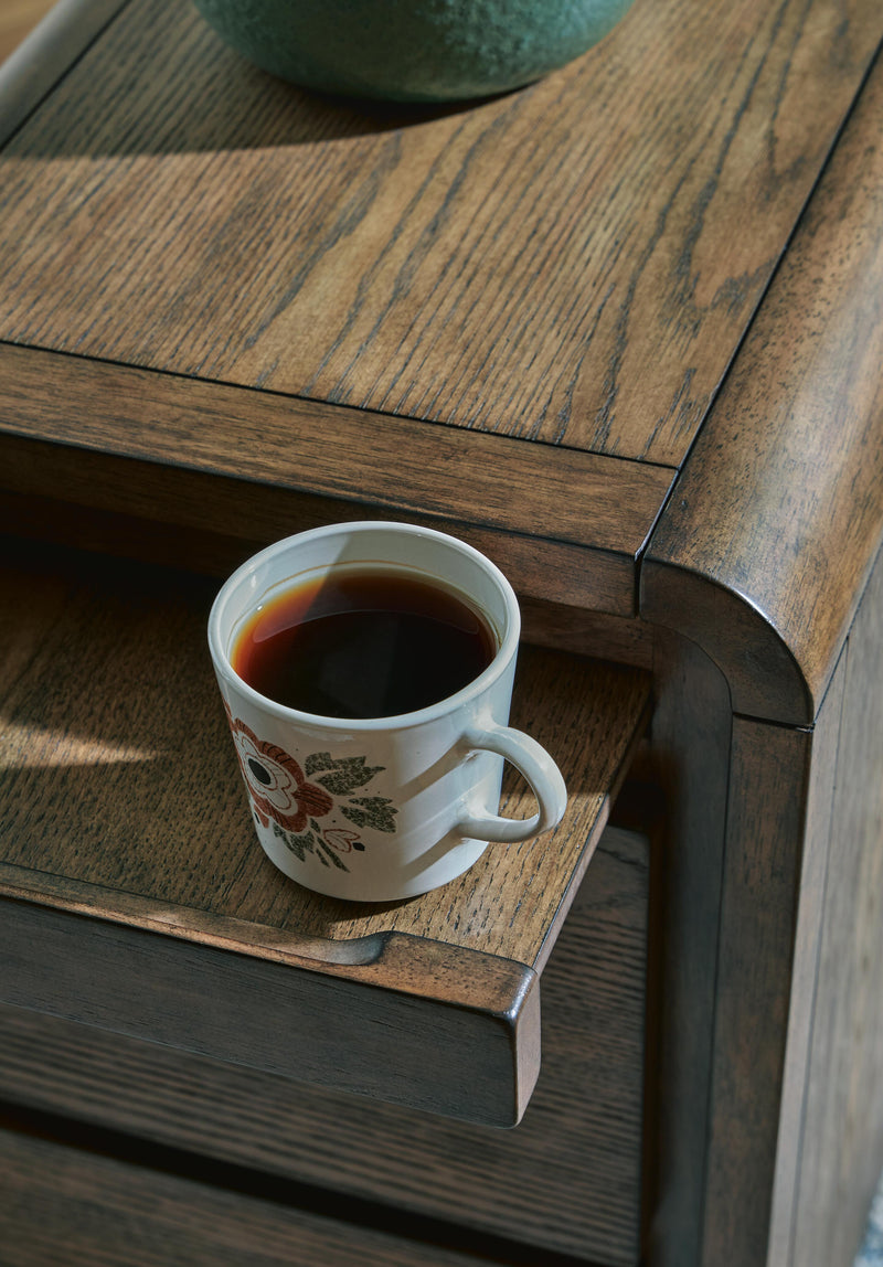 Ashley Furniture Jensworth accent table with a wooden finish and sleek design, perfect for living room or bedroom decor.