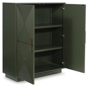 Open Ashley Furniture Geirwood Accent Cabinet showing wood finish, door panels, and interior shelves in a well-lit room.