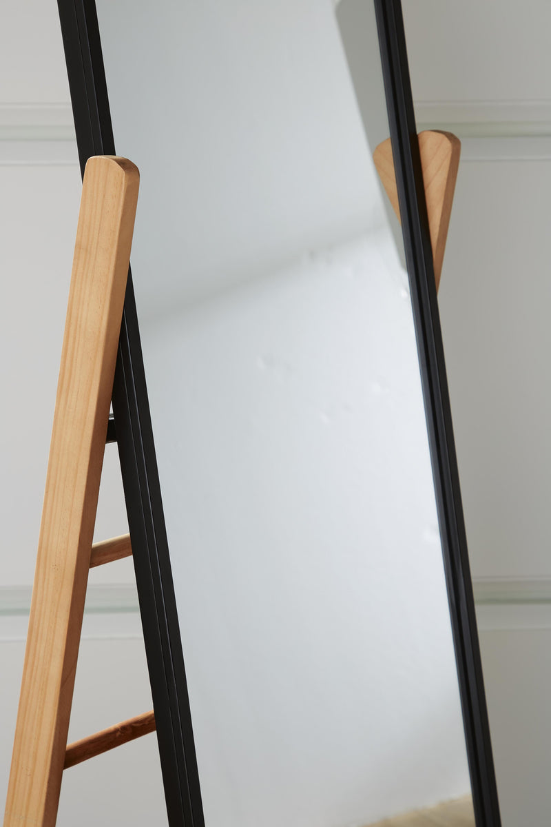 Ashley Furniture Bronick floor mirror, full-length standing mirror with a sleek frame, ideal for bedroom or living room decor.