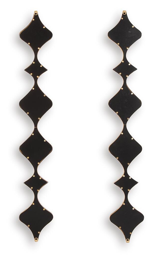 Set of two Harriswood accent mirrors by Ashley Furniture with round, stylish frames, displayed on a wall in a modern interior setting.