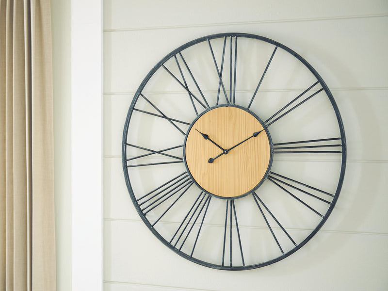 Ashley Furniture Brockett wall clock with a round face and modern design, mounted on a plain background.