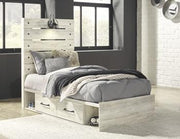 Ashley Furniture Cambeck Bed with 4 storage drawers, featuring a modern wood finish and built-in storage for bedroom organization.