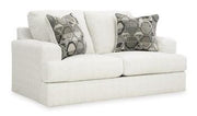 Ashley Furniture Karinne Loveseat with plush fabric and cushioned arms, perfect for cozy living room seating.