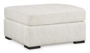 Ashley Furniture Chessington living room set with sofa and armchair, featuring neutral upholstery and wooden accents.