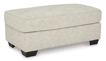 Ashley Furniture Heartcort Ottoman featuring a plush upholstered top and wooden legs for versatile home decor and seating.
